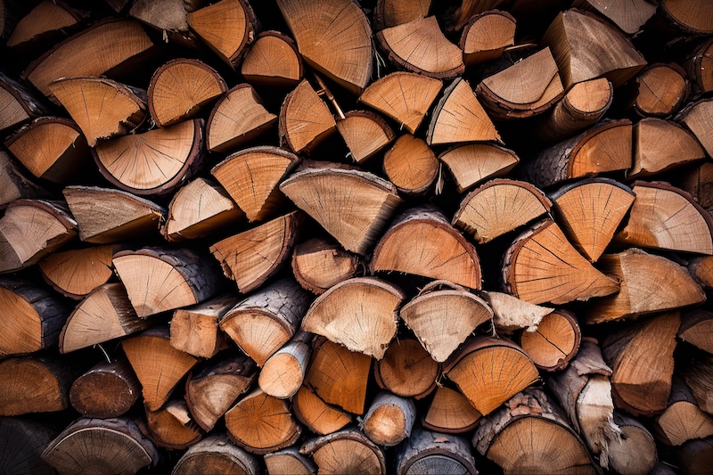 Stacked Split Firewood - Hardwood Logs Cleaving for Seasoned Fuel. Kiln-Dried Background. Generative AI
